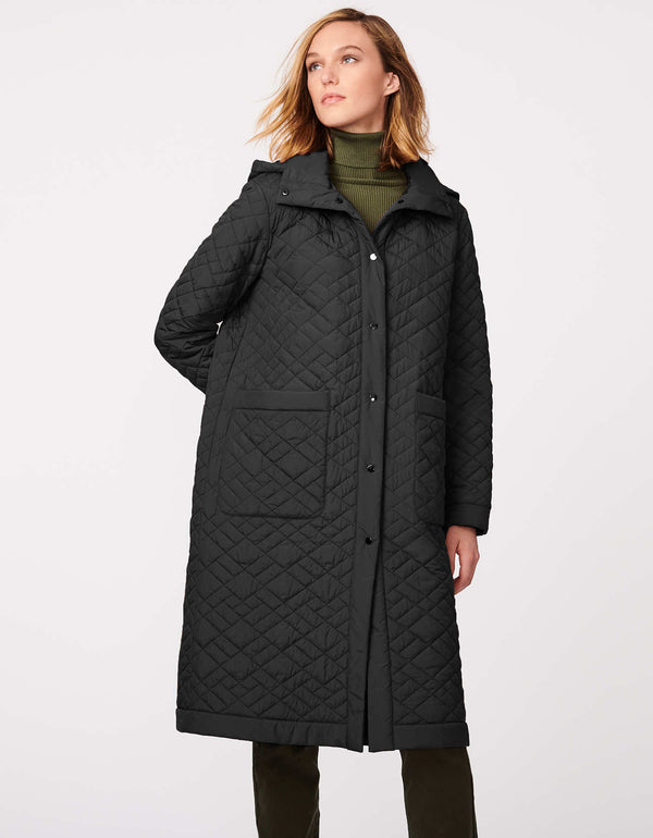 in black color this womens quilted puffer coat is wintertime warm knee length and oversized for layering