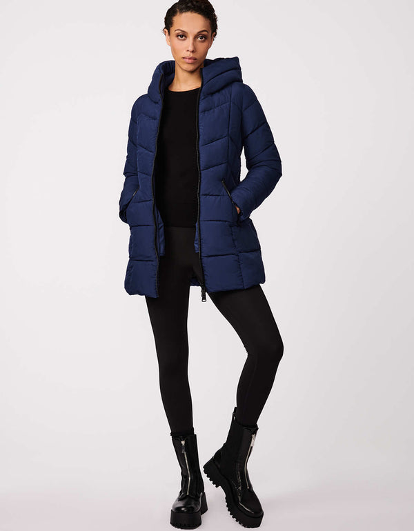 this womens unique dark blue puffer jacket is quilted and warm for winter in a slim fitting mid length silhouette