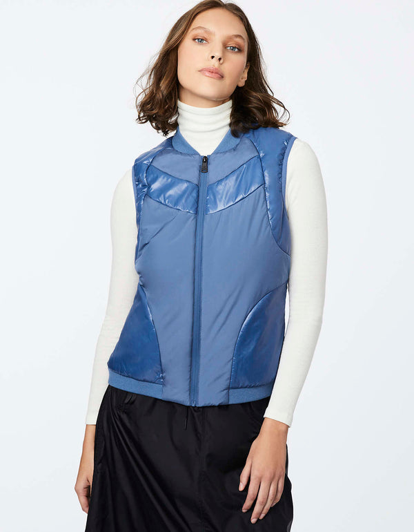hip length blue puffer vest designed with sustainable ecoplume™ filler