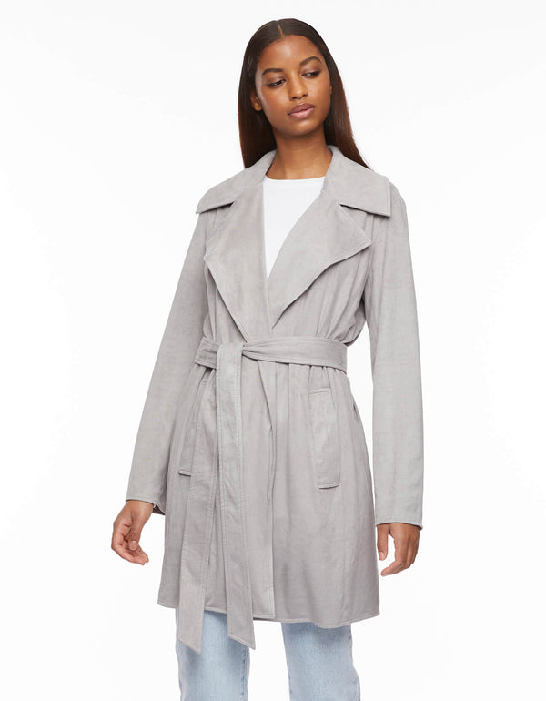 belted wrap jacket in light gray in vegan suede mixes trench styling with a wide lapel tonal waist seam and ample hand pockets
