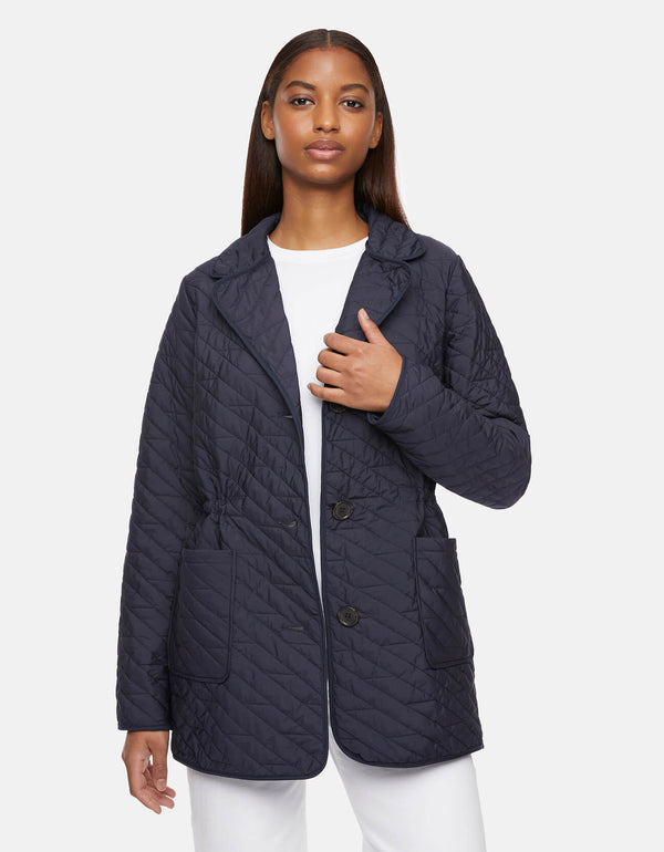 mid length womens light quilted jacket in navy with patch pockets and a trio of buttons as outerwear for women